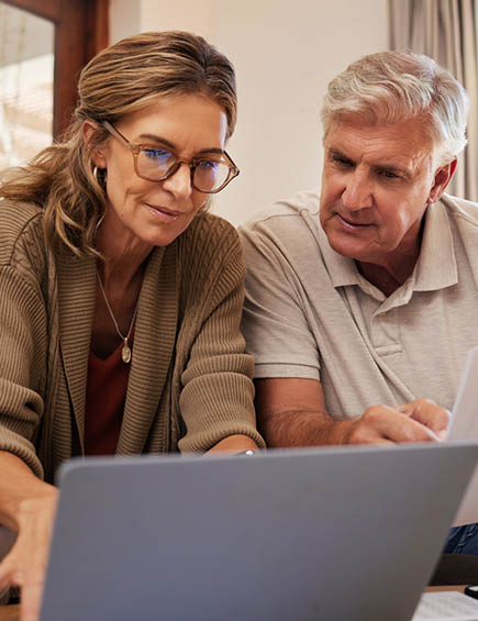 Retirement couple budget, finance and investment planning, loan and paper bills with laptop technology in home. Mature people money, cash savings or legal insurance document report on online bank.