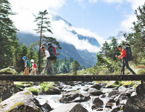 Fathers and children hiking together in mountains